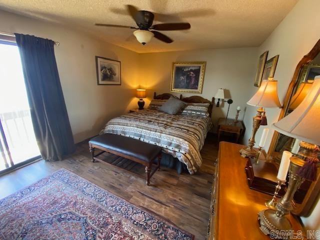 bedroom with ceiling fan, hardwood / wood-style floors, and a textured ceiling