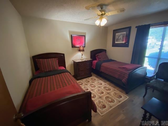 bedroom with ceiling fan and wood-type flooring