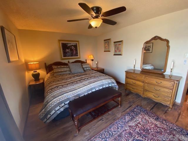 bedroom with dark wood-type flooring and ceiling fan