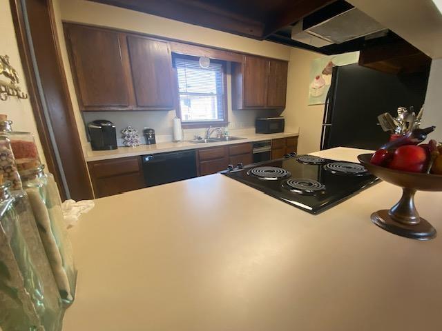 kitchen featuring sink and black appliances