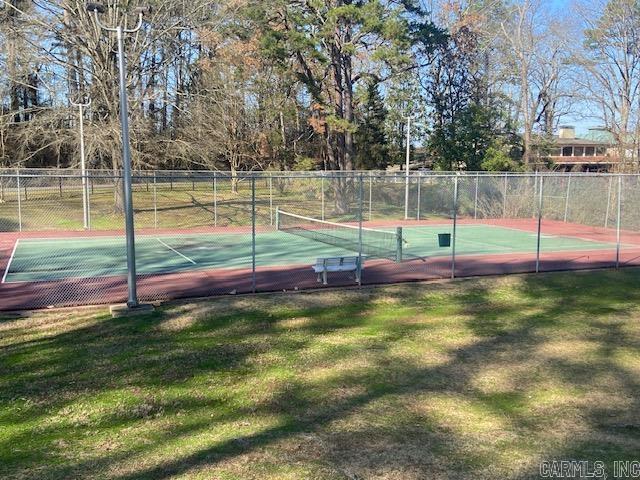 view of sport court with a yard