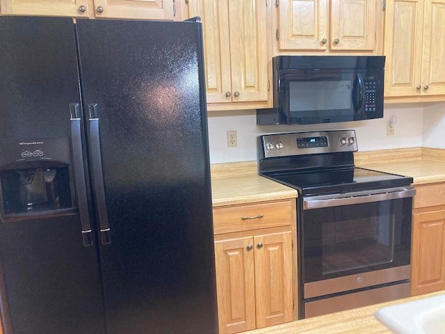 kitchen featuring light brown cabinets and black appliances