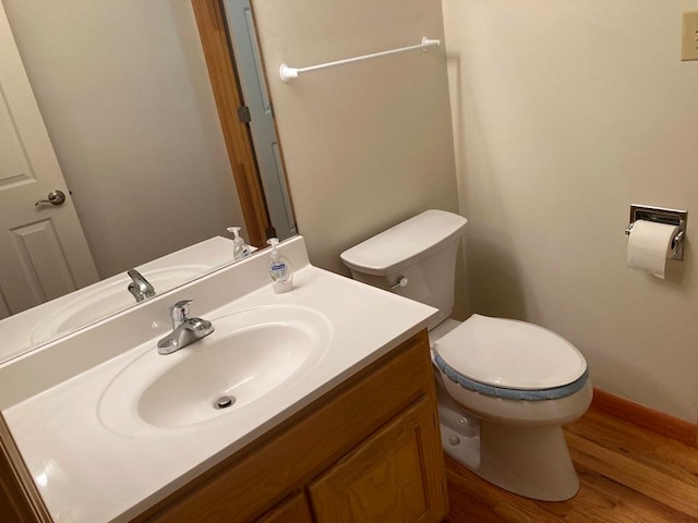 bathroom with vanity, hardwood / wood-style floors, and toilet