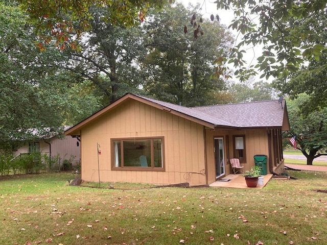 back of property featuring a patio and a yard