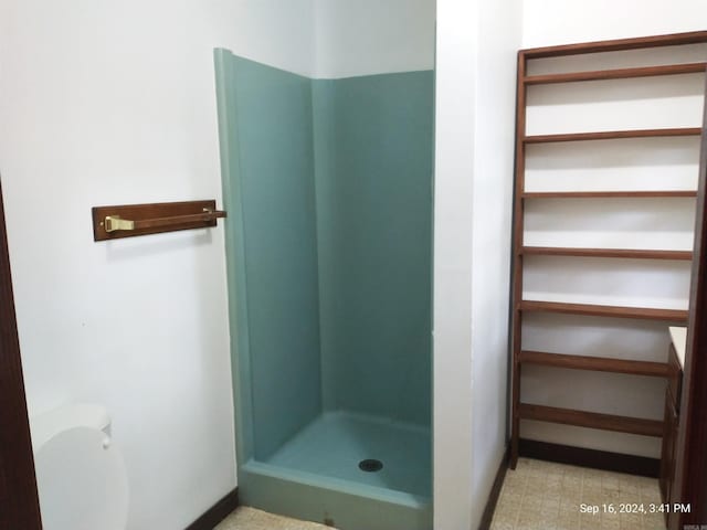 bathroom with walk in shower, vanity, and toilet