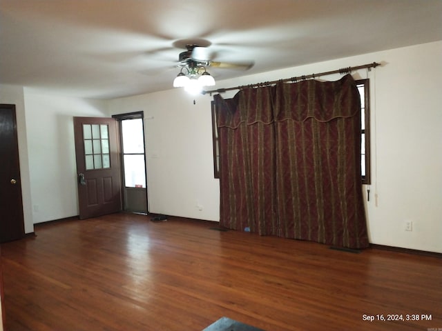 unfurnished room with dark hardwood / wood-style flooring and ceiling fan