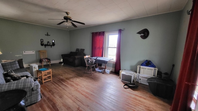 living room featuring ceiling fan and wood-type flooring