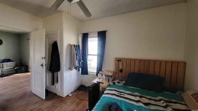 bedroom featuring ceiling fan and hardwood / wood-style floors