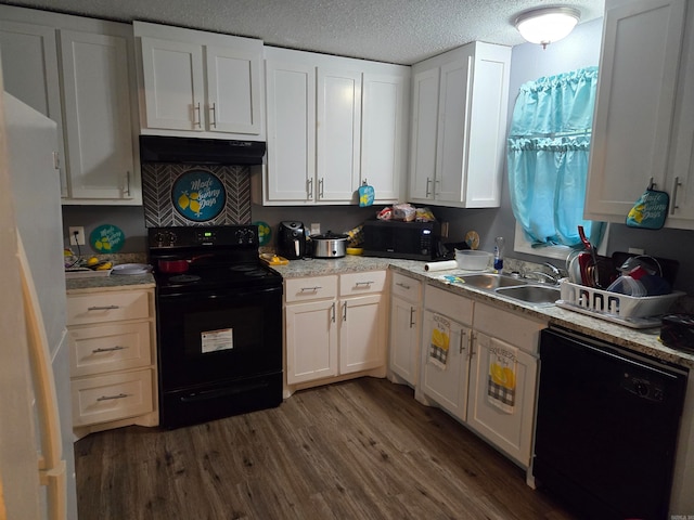 kitchen featuring sink, a textured ceiling, white cabinetry, black appliances, and dark hardwood / wood-style floors