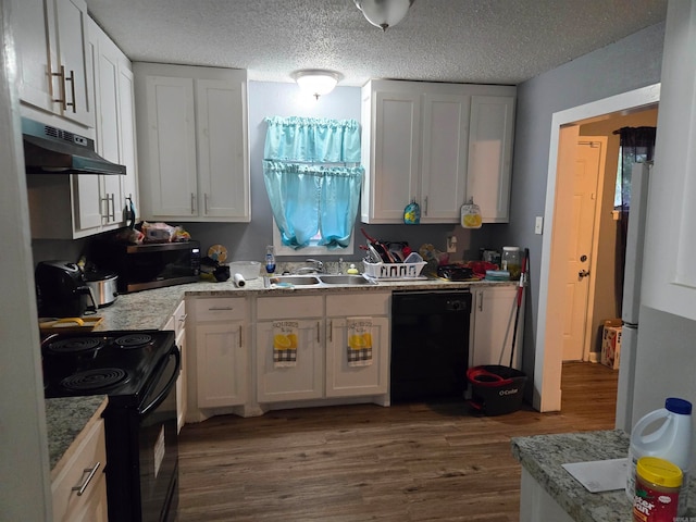 kitchen with black appliances, dark hardwood / wood-style floors, and white cabinets