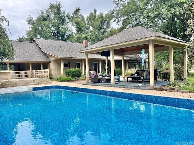 view of swimming pool featuring an outdoor living space, a patio area, a gazebo, and a deck