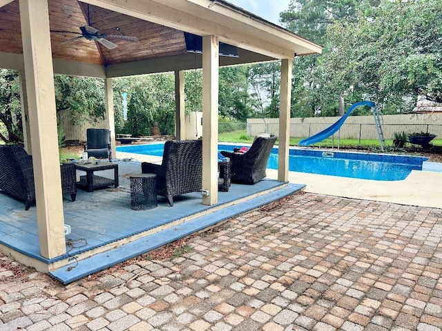 view of patio / terrace featuring a fenced in pool, ceiling fan, a gazebo, and an outdoor living space