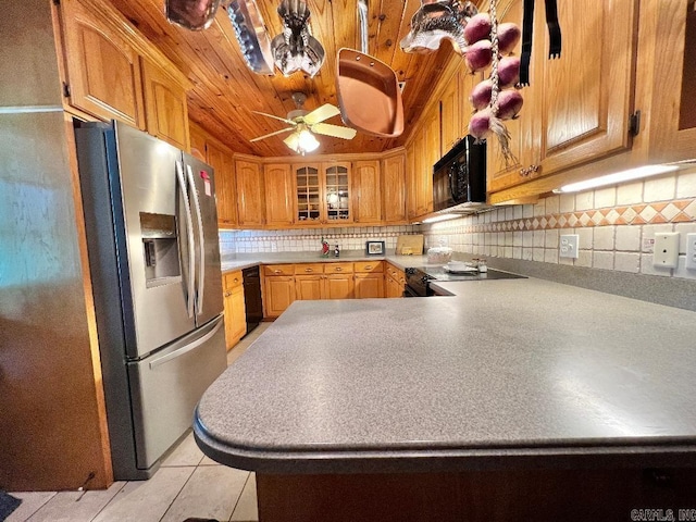 kitchen with ceiling fan, light tile patterned floors, kitchen peninsula, black appliances, and decorative backsplash