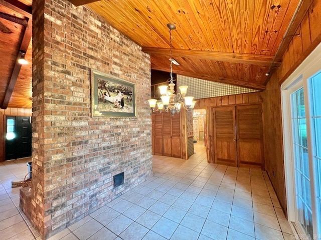 unfurnished living room with an inviting chandelier, light tile patterned flooring, and wooden ceiling