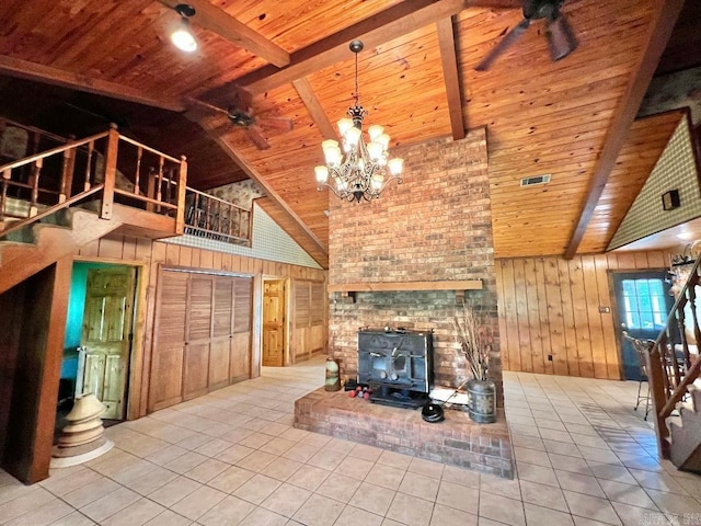 unfurnished living room with wood ceiling, a brick fireplace, wooden walls, high vaulted ceiling, and ceiling fan with notable chandelier