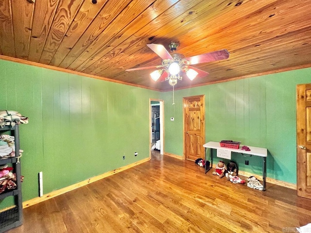 rec room with ceiling fan, ornamental molding, wood-type flooring, and wooden ceiling