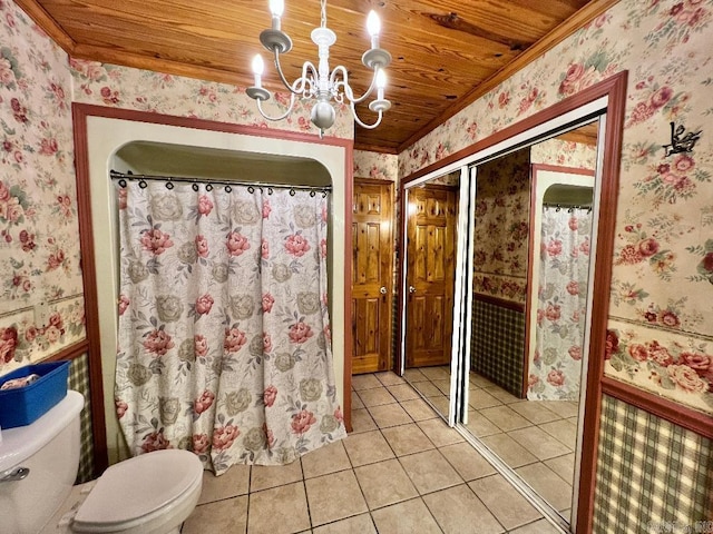 bathroom with wooden ceiling, tile patterned floors, a shower with curtain, a notable chandelier, and toilet