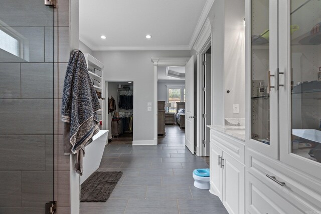 bedroom featuring ornamental molding, wood-type flooring, ceiling fan, and a raised ceiling