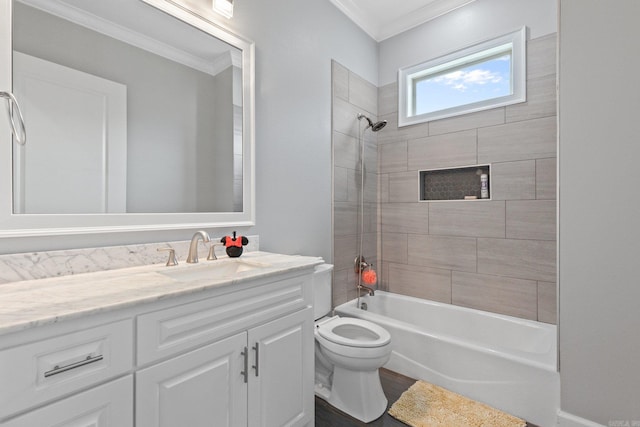 full bathroom featuring vanity, crown molding, tiled shower / bath, and toilet