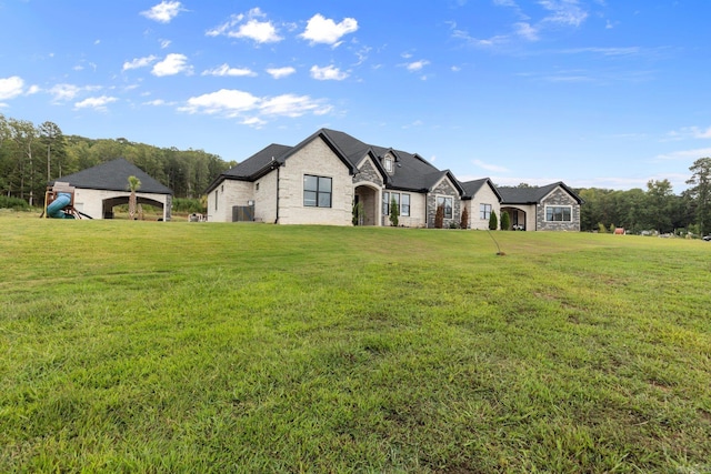 french country style house with a front yard