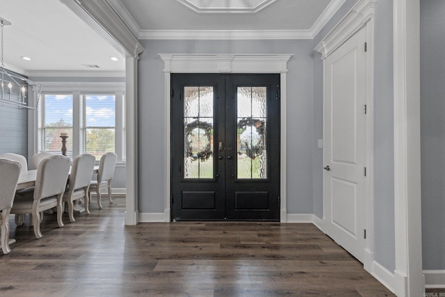 foyer featuring french doors, a notable chandelier, dark hardwood / wood-style floors, and crown molding