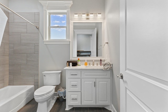 full bathroom with hardwood / wood-style floors, tiled shower / bath combo, vanity, and toilet