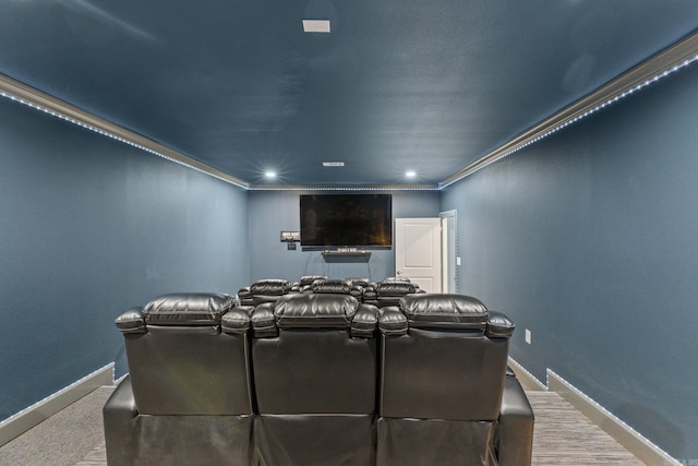 carpeted cinema featuring crown molding