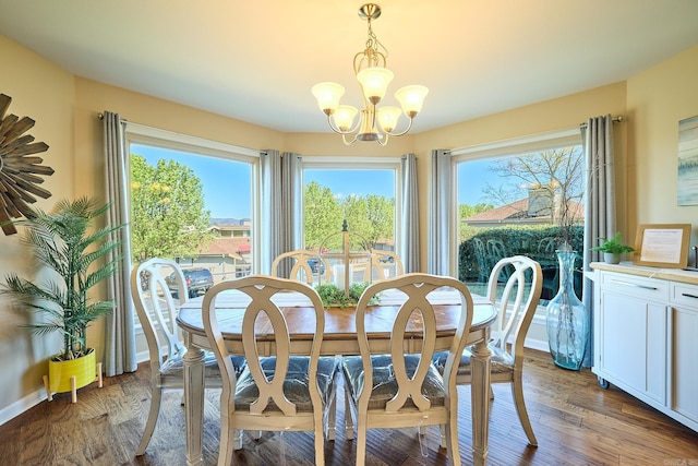 dining space featuring dark hardwood / wood-style floors and a chandelier