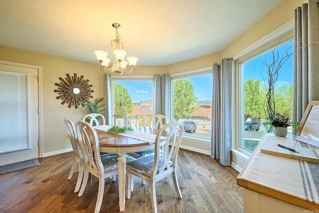 dining room featuring a notable chandelier, plenty of natural light, and dark hardwood / wood-style flooring