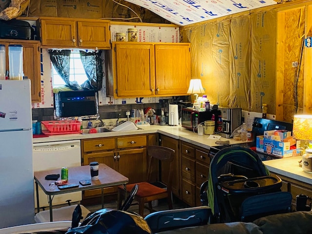 kitchen featuring white appliances and sink