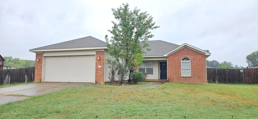 ranch-style home with a front yard and a garage