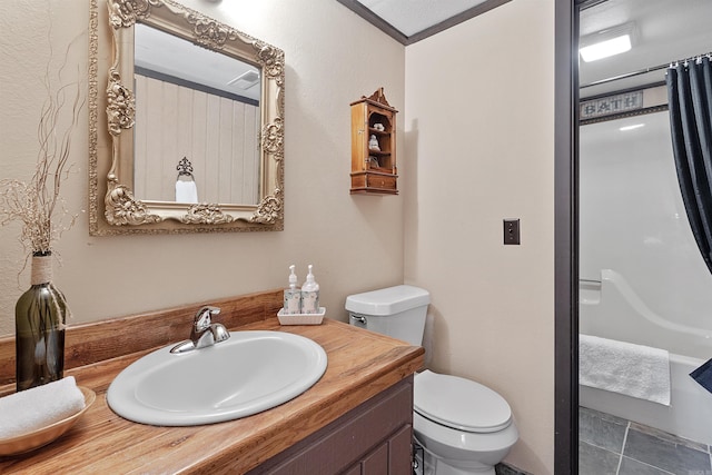 bathroom featuring vanity, tile patterned flooring, toilet, and a textured ceiling