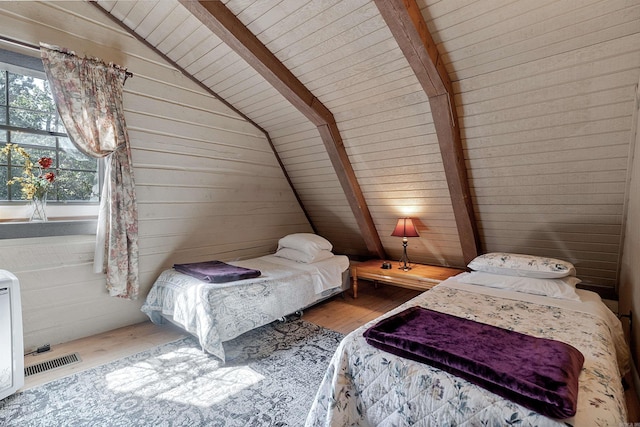 bedroom with wooden ceiling, wooden walls, lofted ceiling with beams, and light hardwood / wood-style flooring