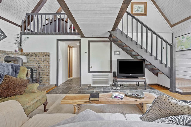 living room featuring radiator, a wood stove, high vaulted ceiling, wooden ceiling, and hardwood / wood-style floors