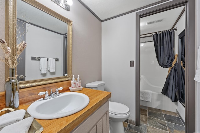 full bathroom with vanity, toilet, a textured ceiling, and shower / bath combo