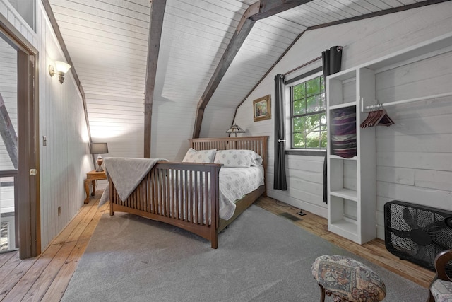 bedroom featuring wooden walls, lofted ceiling, light wood-type flooring, and wood ceiling