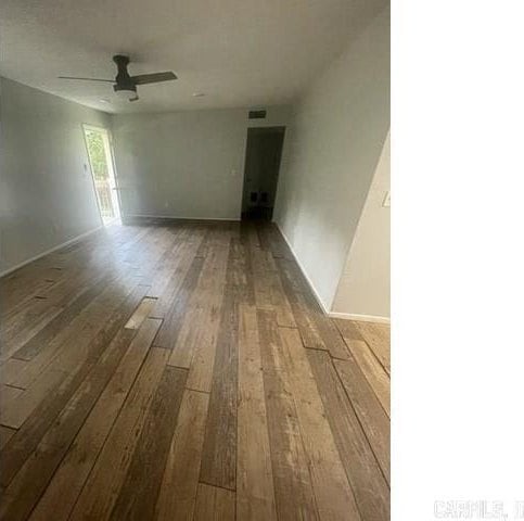 empty room with ceiling fan and hardwood / wood-style floors