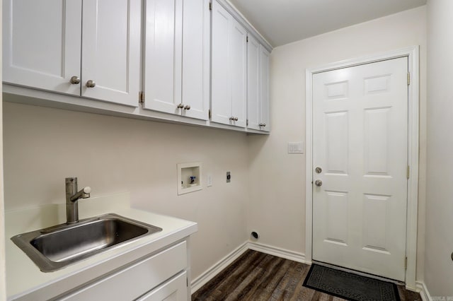 washroom with washer hookup, sink, hookup for an electric dryer, dark wood-type flooring, and cabinets