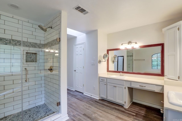 bathroom featuring an enclosed shower, vanity, and hardwood / wood-style flooring