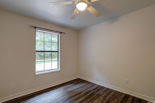 empty room featuring dark wood-type flooring and ceiling fan