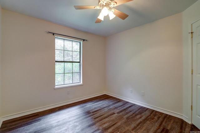 empty room with ceiling fan and dark hardwood / wood-style flooring