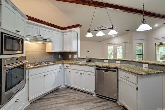 kitchen with decorative light fixtures, stainless steel appliances, and white cabinets