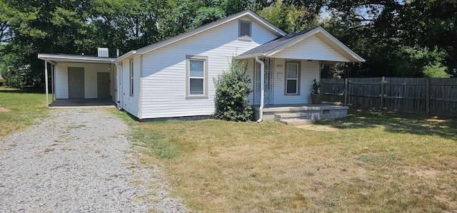 bungalow-style home with a carport and a front yard