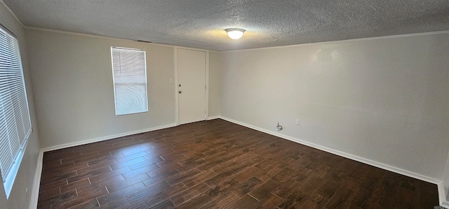 empty room with a textured ceiling, dark hardwood / wood-style floors, and crown molding