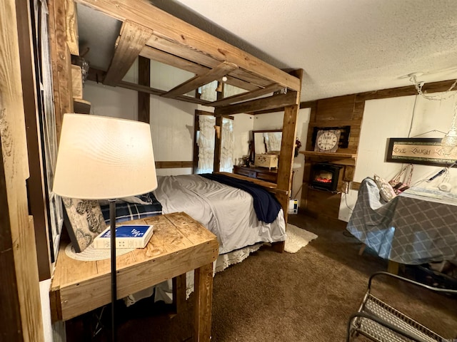 bedroom featuring dark carpet and a textured ceiling