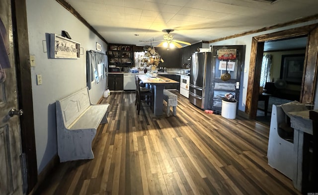 dining area featuring ornamental molding, ceiling fan, and dark hardwood / wood-style flooring