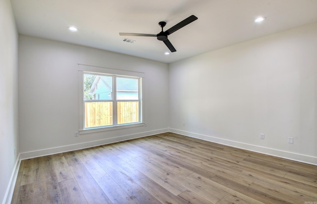 empty room with light hardwood / wood-style floors and ceiling fan