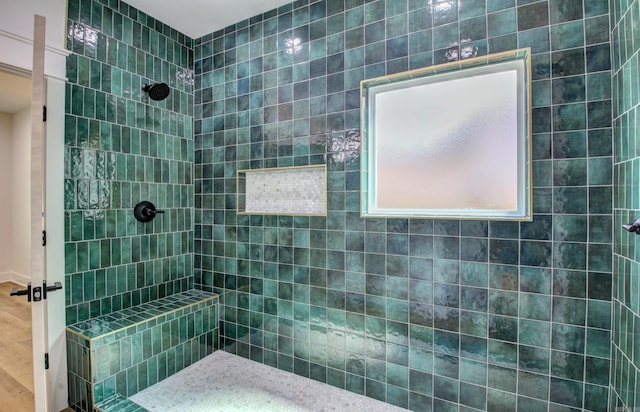 bathroom featuring wood-type flooring and tiled shower