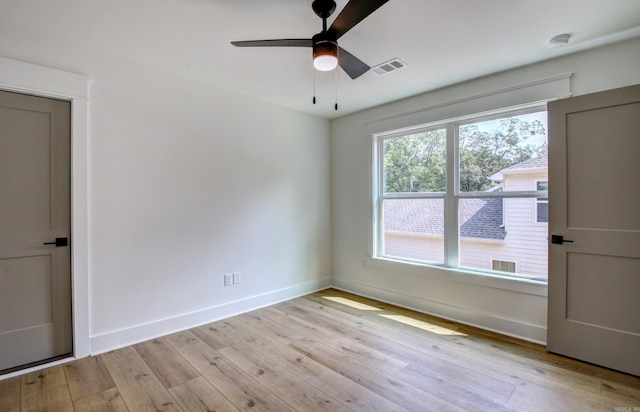 empty room featuring light wood-type flooring and ceiling fan