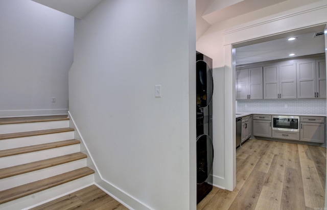 stairs featuring wood-type flooring